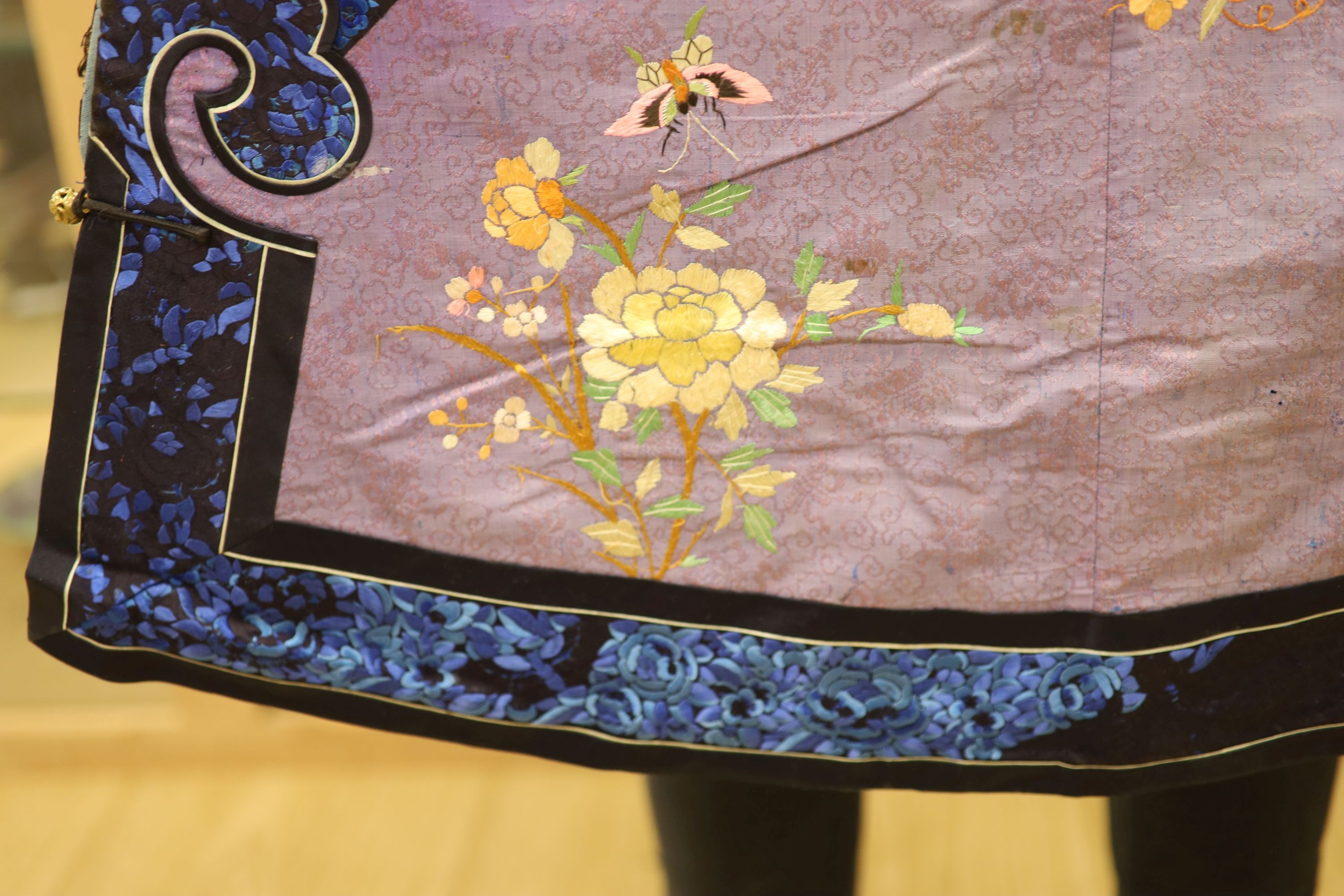 A Chinese lilac silk embroidered robe, early 20th century with multi-coloured embroidery and wide embroidered sleeve bands,